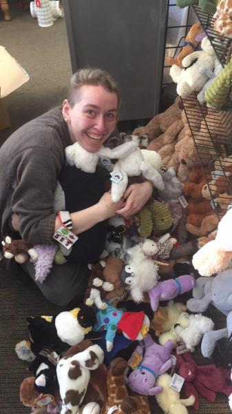 Isabel in a pile of stuffed animals
