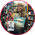 Maddi holding a few of her favorite books in front of her