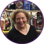 Maureen in front of a shelf of books